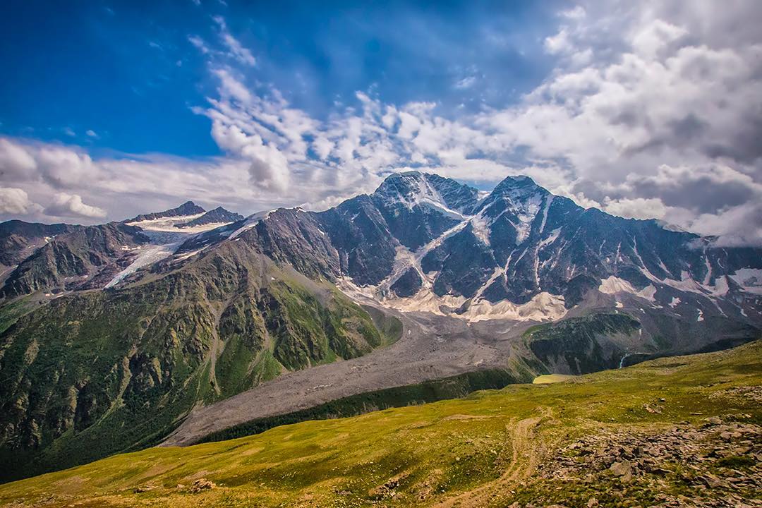 The great Caucasus Mountains rise above the fertile Baksan Valley in the Elbrus region of Russia. ⠀
⠀
I was on an acclimatisation hike to Cheget Peak at 3,601m (11,815ft) before my summit of Mount Elbrus, the highest mountain in Europe at 5,642m (18,510ft), with @klub_7_vershin. The village of Terskol below is the perfect base to start an expedition to Elbrus with easy access to the mountain range. ⠀
⠀
Huge thank you to @SalomonSports and @ellis_brigham who helped get me to the top! #TimeToPlay #livebreatheexplore⠀⠀
-⠀⠀
-⠀⠀
-⠀⠀
-⠀⠀
-⠀⠀
-⠀⠀
-⠀⠀
#elbrus #elbrusexpedition #elbrus2017 #mtelbrus #mountelbrus #Russia #mountains #mountain #Caucasus #caucasusmountains #baksan #summit #7_summits #7summits #mountaineering #adventureawaits #adventureculture #getoutstayout #adventurepic #theoutbound #stayandwander #neverstopexploring #keepitwild #thegreatoutdoors #adventurethatislife