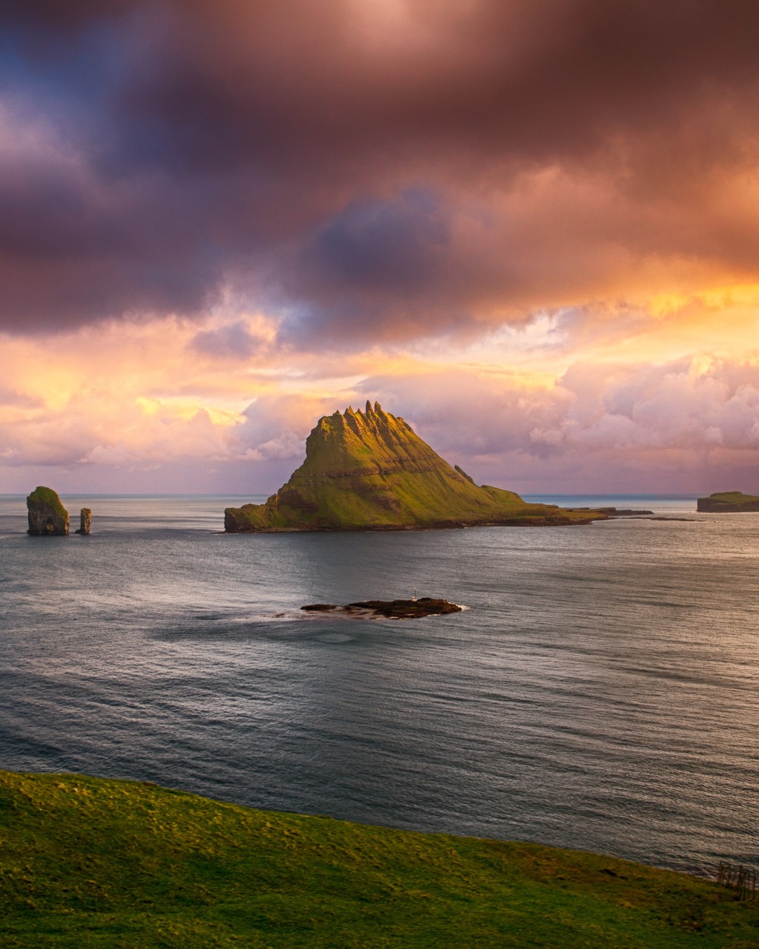 The five-peaked islet of #Tindhólmur on the Faroe Islands during sunset... at 11.13pm!

Deep in the North Atlantic, there is a volcanic archipelago protruding from the untamed waters between Iceland and Norway. This remote clasp of 18 basalt rocks make up the Faroe Islands and are home to stirring fjords, dramatic cliffs and sweeping glaciated valleys.

These islands are repeatedly and relentlessly buffeted by the swells and squalls of the tempestuous Atlantic Ocean. As such, the @visitfaroeislands feature some seriously exciting hiking trails with equally extraordinary scenery.
-⠀
-⠀
-⠀
-⠀
-⠀
-⠀
#faroeislands #visitfaroeislands #atlanticairways #Múlafossur #faroes #faroe #Vágar #lonelyplanet #lppathfinders  #vagar #drangarnir #guidetofaroeislands