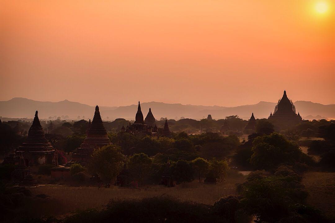 A setting sun lingers over the iconic stupas of the ancient city of Bagan in Myanmar.⠀
⠀
Founded in the second century AD, the kingdom had over 10,000 Buddhist temples, pagodas and monasteries constructed between the 11th and 13th centuries. As it's located in an active earthquake zone, Bagan has suffered from many earthquakes over the ages, which is why today the remains of "only" 2000 temples and pagodas can be seen.⠀
⠀
Bagan was the last day in the saddle of our cycle tour on assignment with @gadventures and @lonelyplanet.⠀
⠀
#lpPathfinders #GAdv #lonelyplanet #Bagan #Myanmar #Burma #Mandalay #light #mystic  #temples #pagoda #stupa #travel #travelgram #wanderlust #instatravel #adventure #view #tranquility #Burmese #sunset