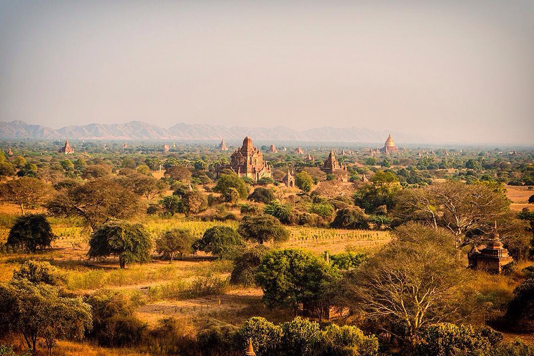 Our first glimpse of Bagan after nearly two weeks in Myanmar. 
Sprawling across an area of 26 square miles, Bagan is the world's largest and densest concentration of Buddhist temples, pagodas, stupas and ruins. ⠀
⠀
We arrived after cycling 60km from Mount Popa on assignment with @gadventures and @lonelyplanet. We were feeling somewhat templed out but our first view of Bagan had us eager to explore once more. ⠀
⠀
#lpPathfinders #GAdv #lonelyplanet #Bagan #Myanmar #Burma #Mandalay #light #mystic  #temples #pagoda #stupa #travel #travelgram #wanderlust #instatravel #adventure #view #tranquility #Burmese