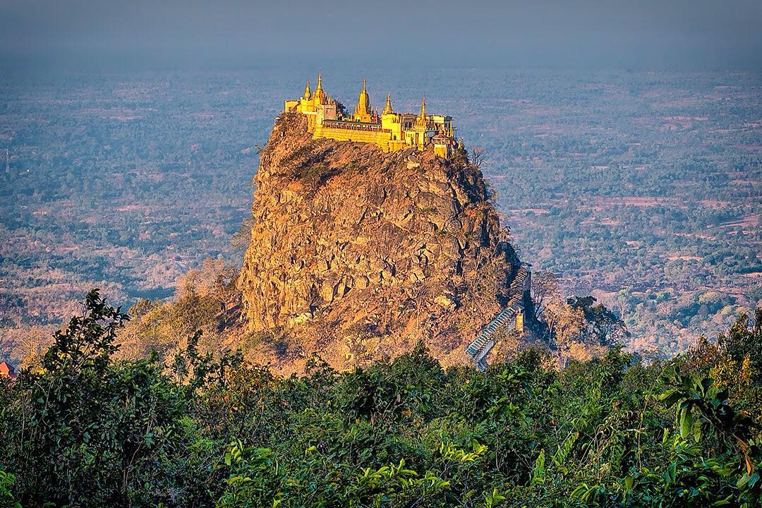 Looking out at Taung Kalat and its Buddhist monastery from Mount Popa in Myanmar.⠀
⠀
Taung Kalat (pedestal hill) rises 657m (2,156ft) above sea level, where a Buddhist monastery is located at the summit. The Buddhist hermit U Khandi used to maintain the stairway of 777 steps to the summit until his death in 1949.⠀
⠀
Our group arrived at Mount Popa after a gruelling 83km uphill cycle ride. At the end of the climb we arrived to Popa Mountain National Park with cold drinks, a hearty lunch and this view waiting for us. On assignment with @gadventures and @lonelyplanet.⠀
⠀
#lpPathfinders #GAdv #lonelyplanet #Myanmar #popa #PopaMountain #MountPopa #Burma #travel #travelgram #wanderlust #instatravel #adventure #view #travelphotography #PopaMountainNationalPark
