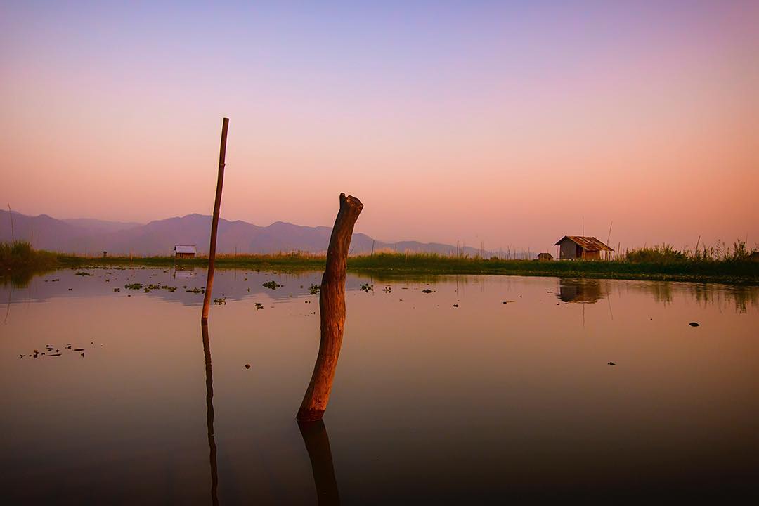 Looking across the still and serene Inle Lake at #sunset from the Nga Hpe Kyaung Monastery, #Myanmar.⠀
⠀
The ‘Jumping Cat Monastery’ is famous for the cats once trained to jump through hoops. Any cats there now are not so much jumping as they are lazing. Still, the final stop on our Inle Lake boat tour was well worth a pause. The echoing main chamber of the monastery maintains a softly sedate mood, perfect for pause and reflection. ⠀
⠀
And with views like this outside the monastery it's hard not to submit to a dash of the Buddhist spiritualism that permeates Myanmar.⠀
-⠀
-⠀
-⠀
-⠀
-⠀
-⠀
#nyaungshwe #boat #Asia #inle #Burma #inlelake #travelgram #wanderlust #ic_adventures #global_hotshotz #lpfanphoto #passionpassport #worldtravelbook #exploretocreate #theoutbound⠀
#lpPathfinders #adventureawaits #adventureculture #traveldeeper #stayandwander #travelawesome #optoutside #getoutstayout