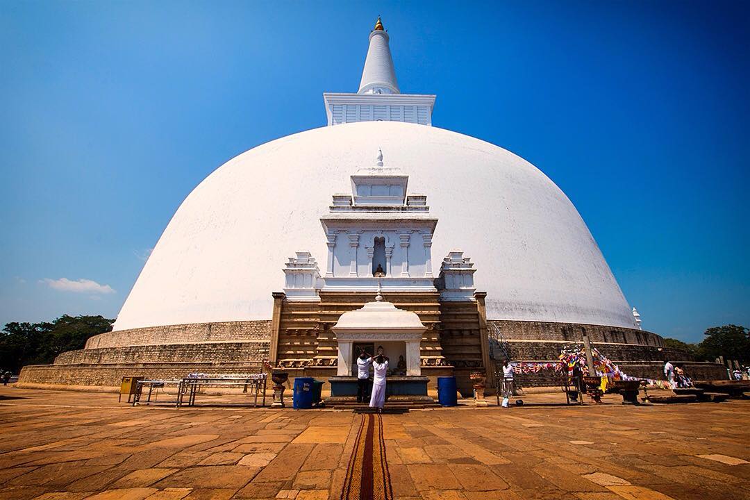 People offer their prayers at the Ruwanweliseya Dagoba in the ancient city of Anuradhapura, Sri Lanka.⠀
⠀
Ruwanweliseya is one of the oldest structures in Anuradhapura (albeit rigorously restored in recent years). The ancient city of Anuradhapura has a long and illustrious past. Established in 4th century BC, it is among the oldest continuously inhabited cities in the world. It is one of Sri Lanka’s ancient capitals and was the center of Theravada Buddhism for centuries.⠀⠀
⠀⠀
Today, Anuradhapura is a UNESCO World Heritage Site, spread over an area of 40 sq km (15 sq mi). We saw the sprawling ancient city in a day by hiring bicycles to get around. ⠀⠀
-⠀⠀
-⠀⠀
-⠀⠀
-⠀⠀
-⠀⠀
-⠀⠀
#Anuradhapura #SriLanka #lka #ruins #cycling #Sri_Lanka #photo #VisitSriLanka #Ruwanwelisaya #Lanka #ceylon #IndianOcean #ocean #srilankaecotourism #Abhayagiri #Dagaba #stupa #pagoda #lpPathfinders #lpfanphoto @lonelyplanetmags #adventureawaits #adventureculture #traveldeeper
