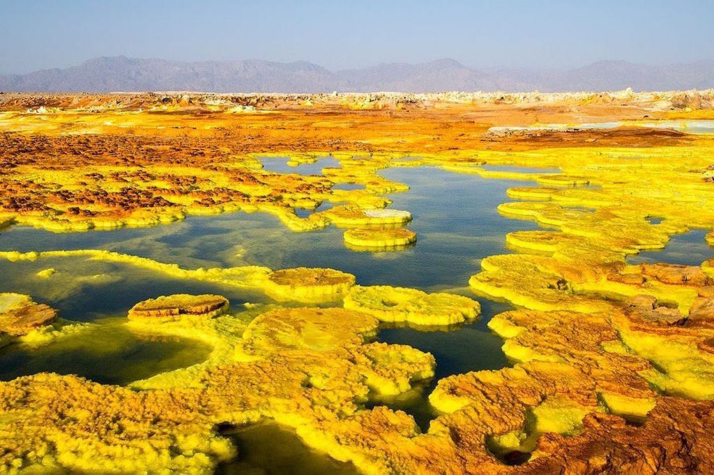 This surreal landscape of Dallol in the Afar region of Ethiopia is home to hottest inhabited place on Earth.⠀
⠀
In another part of the world in another time Dallol may well have been a far more popular tourism destination than it is, considering it boasted an average daily maximum temperature of 41.1 °C (106.0 °F) between 1960 to 1966. ⠀
⠀
We've just got back from visiting the Danakil Depression, where Dallol is located, at -130m (-430ft) below sea level. This was just one of the raw landscapes we encountered in one of the most inhospitable parts of the world, here in Ethiopia.
-
-
-
-
-
-
-
#Dallol #Danakil #DanakilDepression #Afar #AfarRegion #adventurethatislife #liveoutdoors #awesomepix #ourlonelyplanet #travelawesome #passionpassport  #danikaldesert #colorfulhotspring #hottestplace #hottestplaceonearth #extemeheat #travelawesome #optoutside #earthpix #neverstopexploring #keepitwild #thegreatoutdoors #lpfanphoto @lonelyplanetmags #lppathfinders