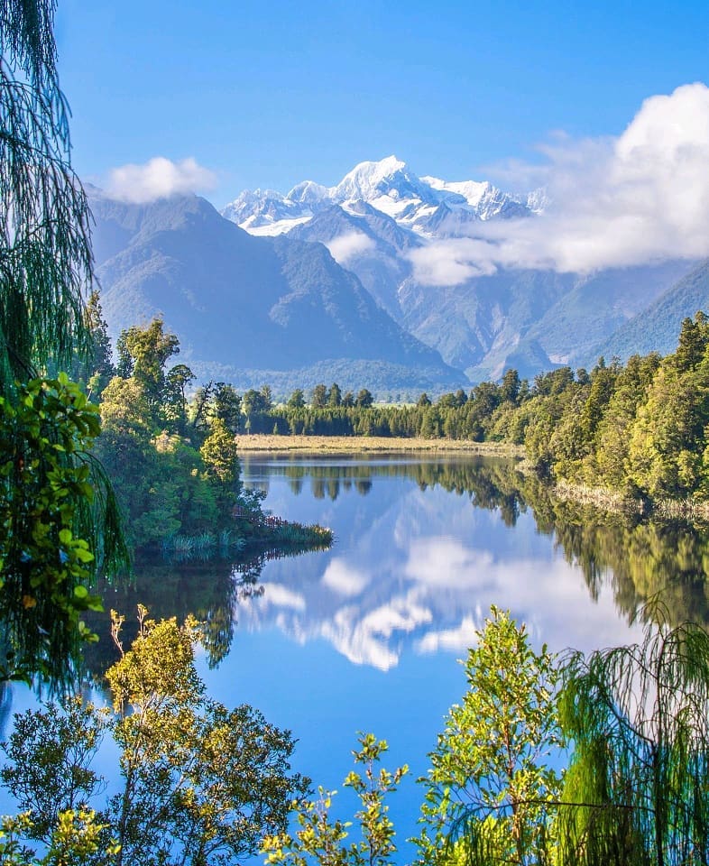 Looking across the still waters of Lake Matheson at New Zealand's highest and second highest mountains, Aoraki/Mount Cook and Mount Tasman, during our tour of the South Island with @gadventures and @lonelyplanet.⠀
⠀
The gentle hike around Lake Matheson boasts some of the most serene vistas we've ever seen with the Southern Alps majestically reflected in the tranquil waters of the lake. ⠀
-⠀⠀
-⠀⠀
-⠀⠀
-⠀⠀
-⠀⠀
-⠀⠀
#Aoraki #MountCook #mountcooknz #MountTasman #MtCook #SouthernAlps #Matheson #LakeMatheson #FranzJosef #foxglacier #mountcooknationalpark #southislandnewzealand #southisland #southislandnz #newzealand #NZMustDo #RealMiddleEarth #NZ #visitnewzealand #lppathfinders #gadventures #liveoutdoors #bestintravel #thegreatoutdoors #wellhiked #takeahike #hikingadventures #getoutstayout #ig_newzealand #purenewzealand