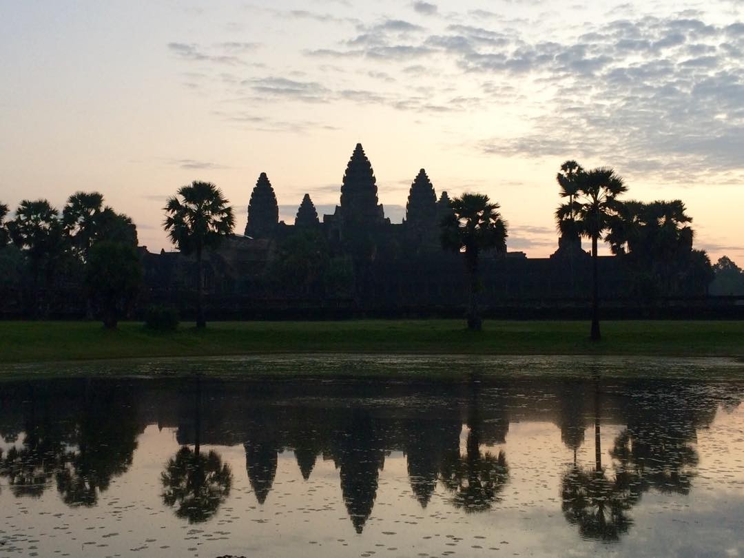 The temples of Angkor Wat at sunrise, Siem Reap, Cambodia 🇰🇭. A UNESCO world heritage site, it is one of only a few Buddhist sites that was not destroyed by Pol Pot and his Khmer Rouge regime.

#travel #angkorwat #siemreap #cambodia #Unesco #sunrise #palmtrees #reflection #Khmer