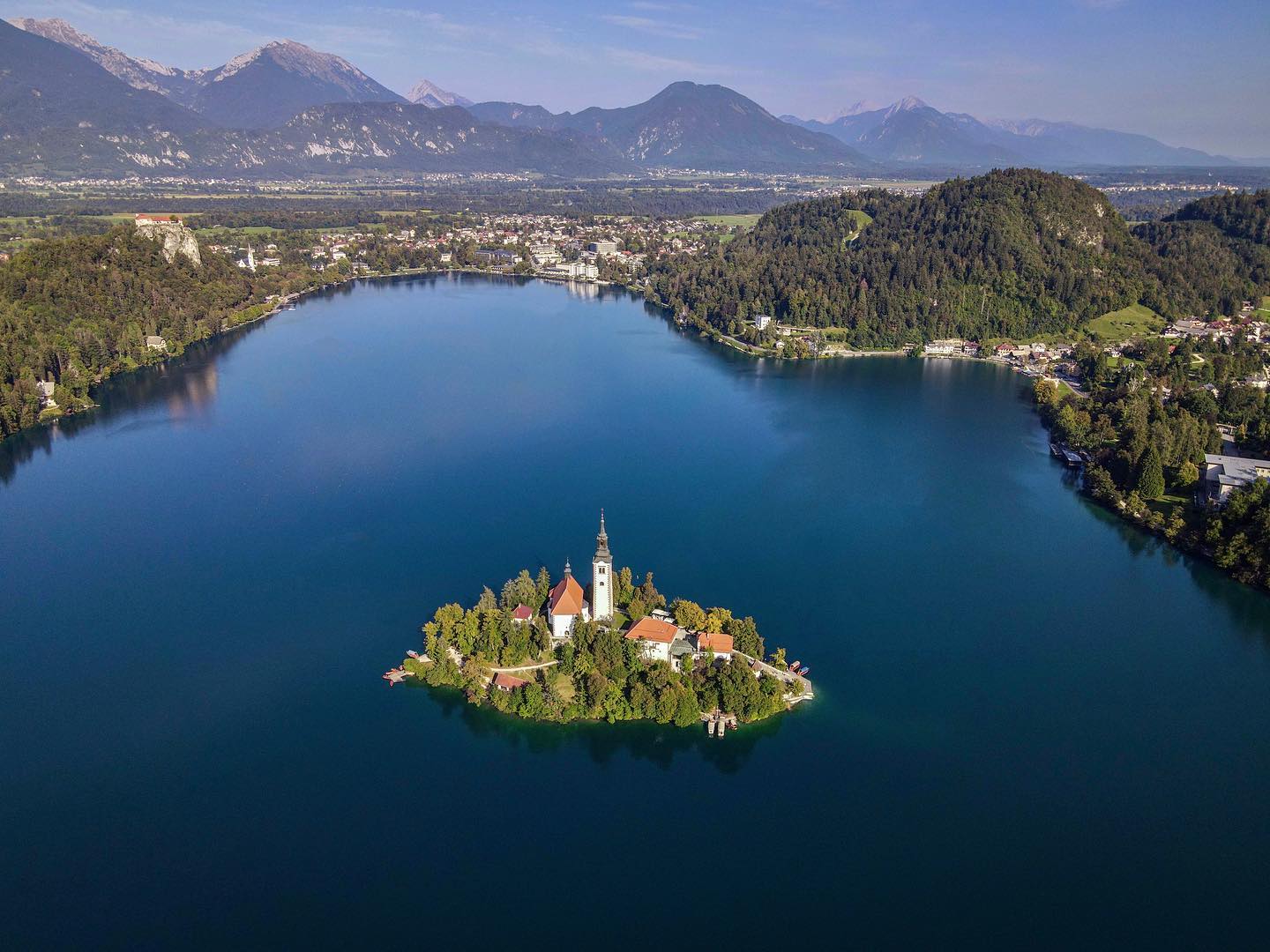 Lake Bled is one of the most picturesque spots to visit in Slovenia. This small lake has all of the ingredients for the perfect getaway…a castle perched high on a hillside, a pretty little island to visit, hiking trails, secluded swimming spots, and a fantastic sweet treat. 
.
.
.
#bled #lake #lakebled #slovenia #sloveniatravel #slovenia_ig #visitslovenia #slowenien #boat #bledslovenia #drone #droneshot #island #dronephotography #droneshots #dronestagram #droneoftheday #mavicair2 #dji #djimavicair2 #dronefly #drohne #bledcastle  #drohnenfotografie #bledersee #bledlake #travel #sloveniadrone #bledisland #exploringslovenia @slovenia @feelslovenia @loveslovenia @slovenia_lovers @exploringslovenia @slovenians_travel @bestofslovensko @igslovenia @slovenia.insta @best.europe.photos @_igeuropa @besteurope @incredible_europe @europe_moments @europestyle_ @fstopgear @dronemperors